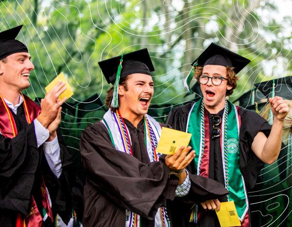 Students in graduation attire holding diplomas during a graduation ceremony